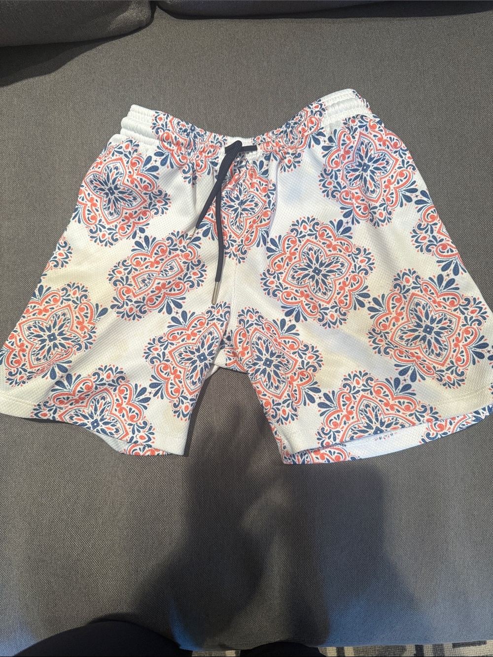 Drip Shop Patterned White Athletic Shorts with Coral and Navy Medallions